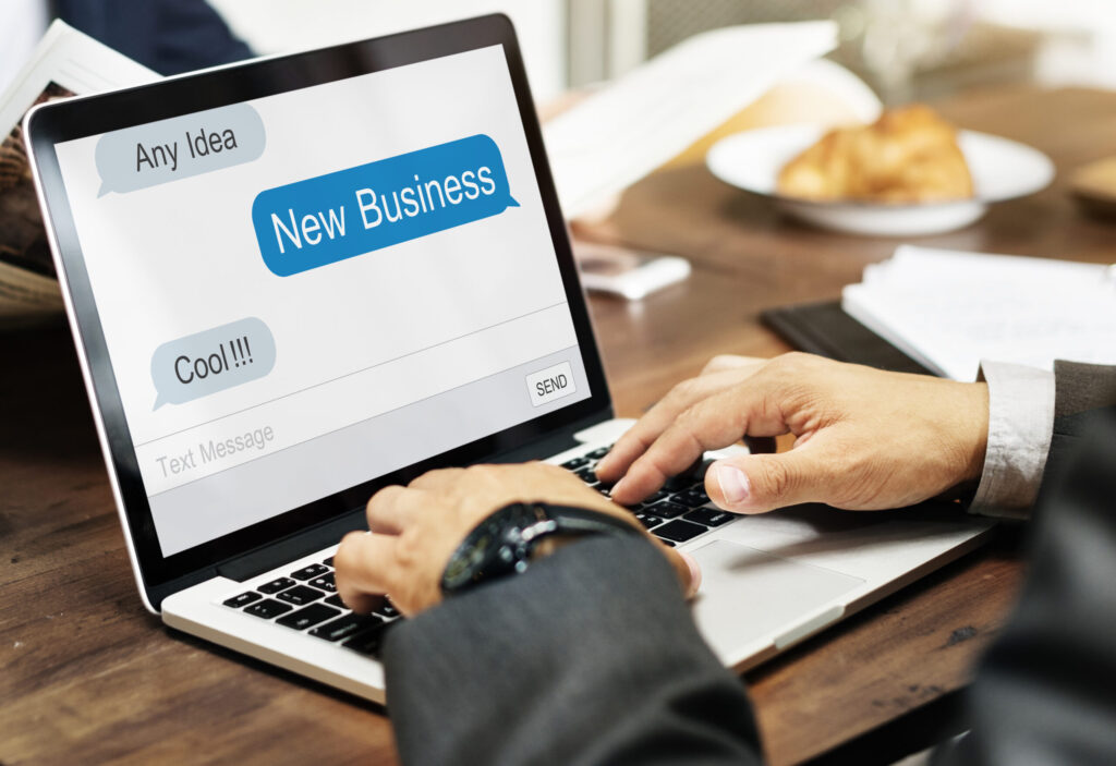 Laptop displaying business message popups representing Google Ads lead generation and digital marketing in Sharjah