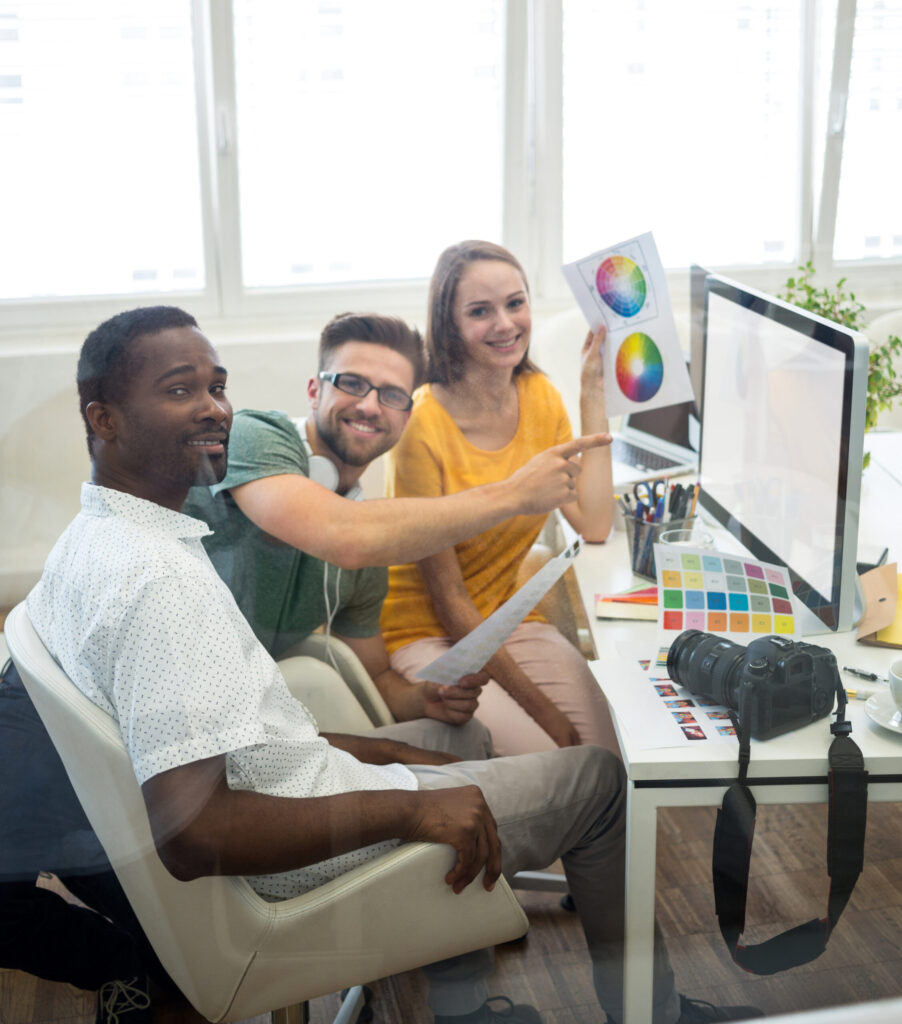 Creative team collaborating on brand design and digital marketing content in an office setting