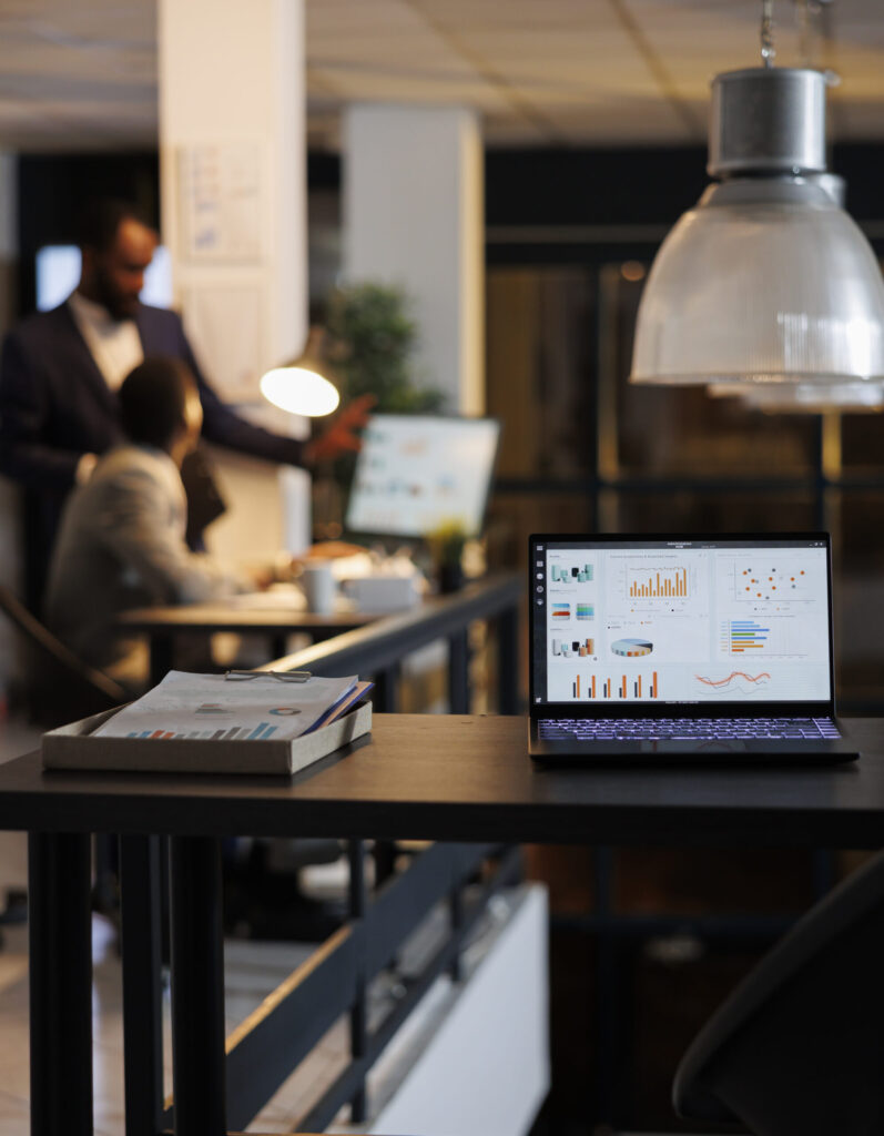 Laptop displaying financial analytics on screen in a digital marketing office setting
