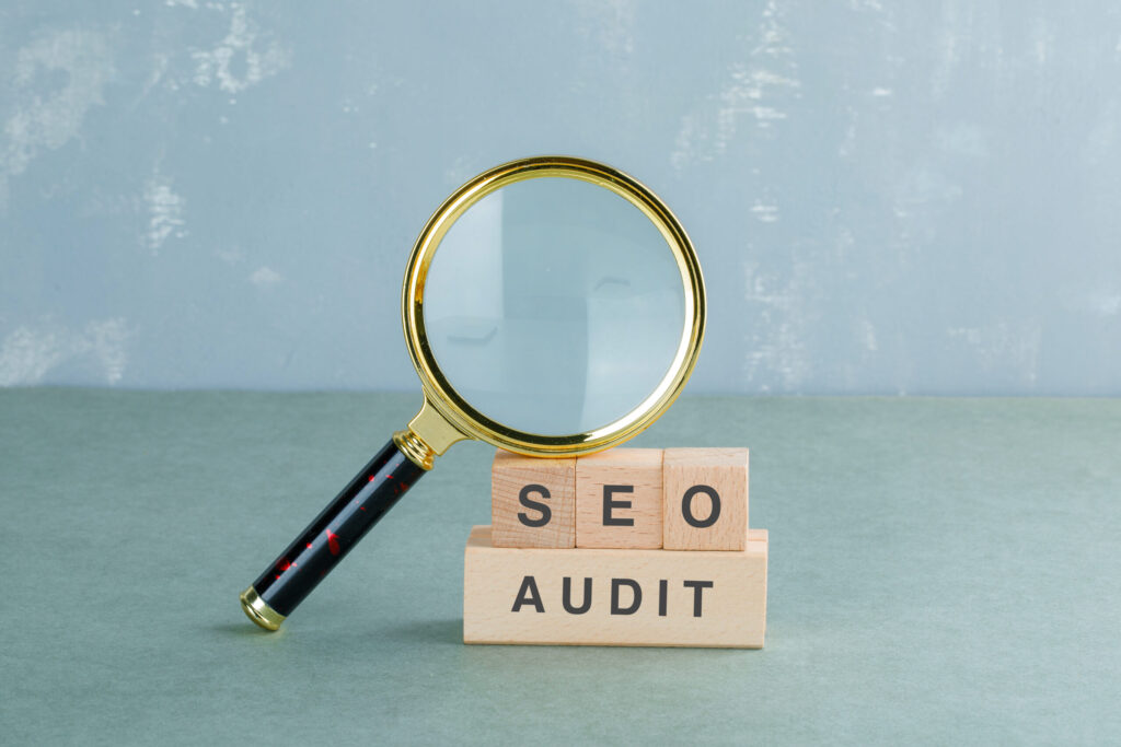 SEO audit services in Sharjah UAE with magnifying glass and audit blocks